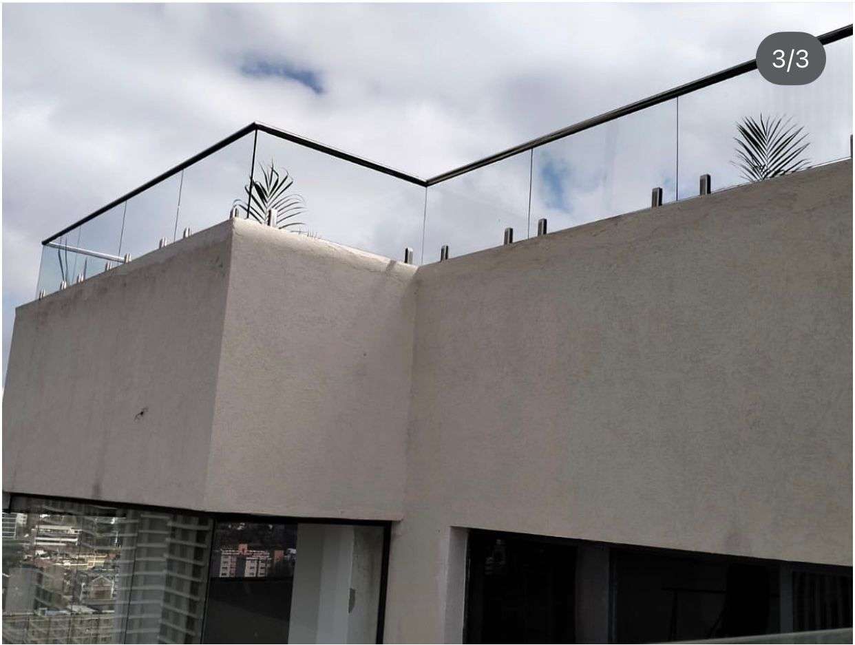 supply and installation of balcony railing compromising of stainless steel balustrade posts and tempered/ laminated glass partitions in nairobi kenya by top construction and finishing experts aura renovations and interiors