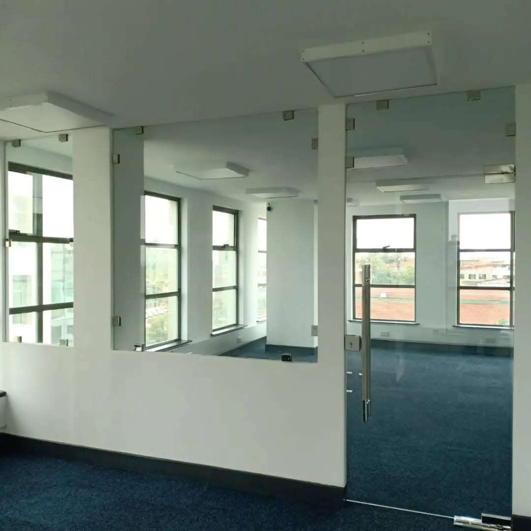 Modern office glass partition systems installed in a contemporary corporate office by Aura Renovations and Interiors.