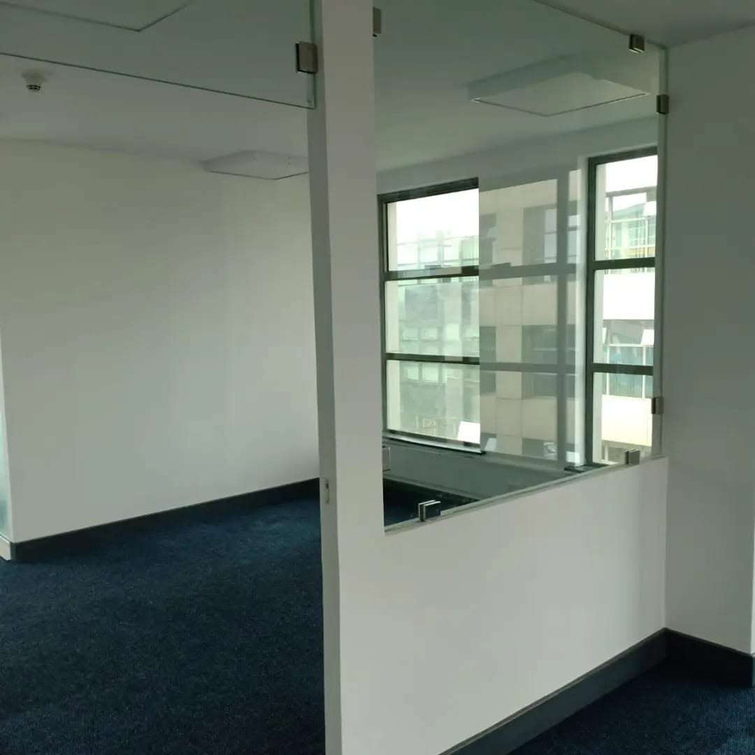 Modern office glass partition systems installed in a contemporary corporate office by Aura Renovations and Interiors.